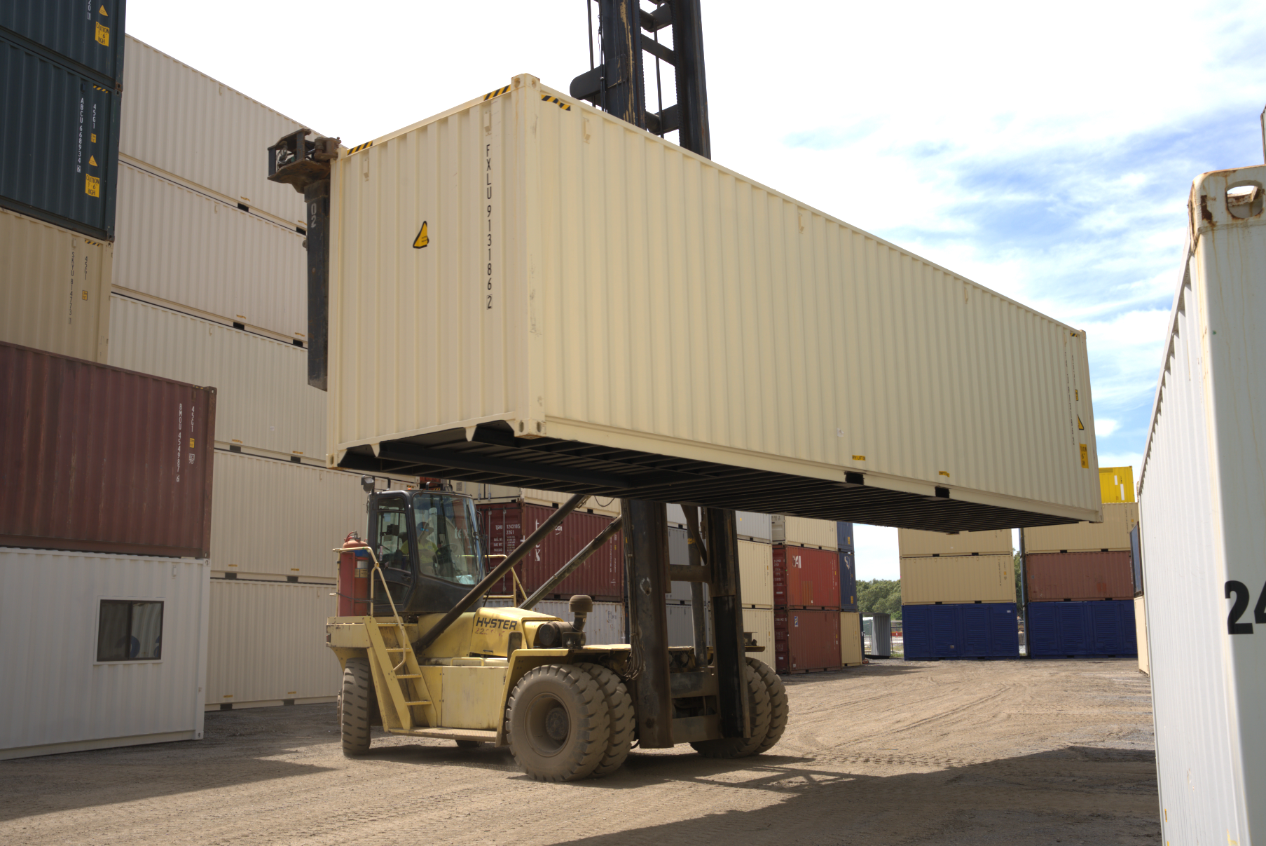 40ft shipping container being picked up by a forklift