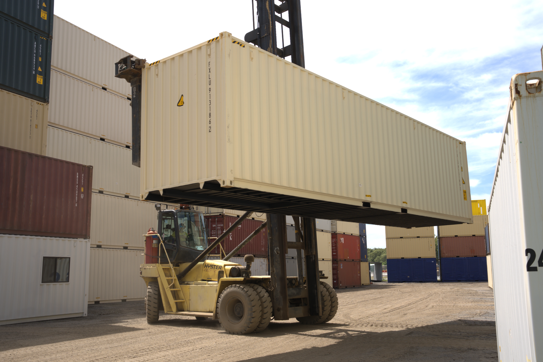 40ft shipping container lifted up by a forklift