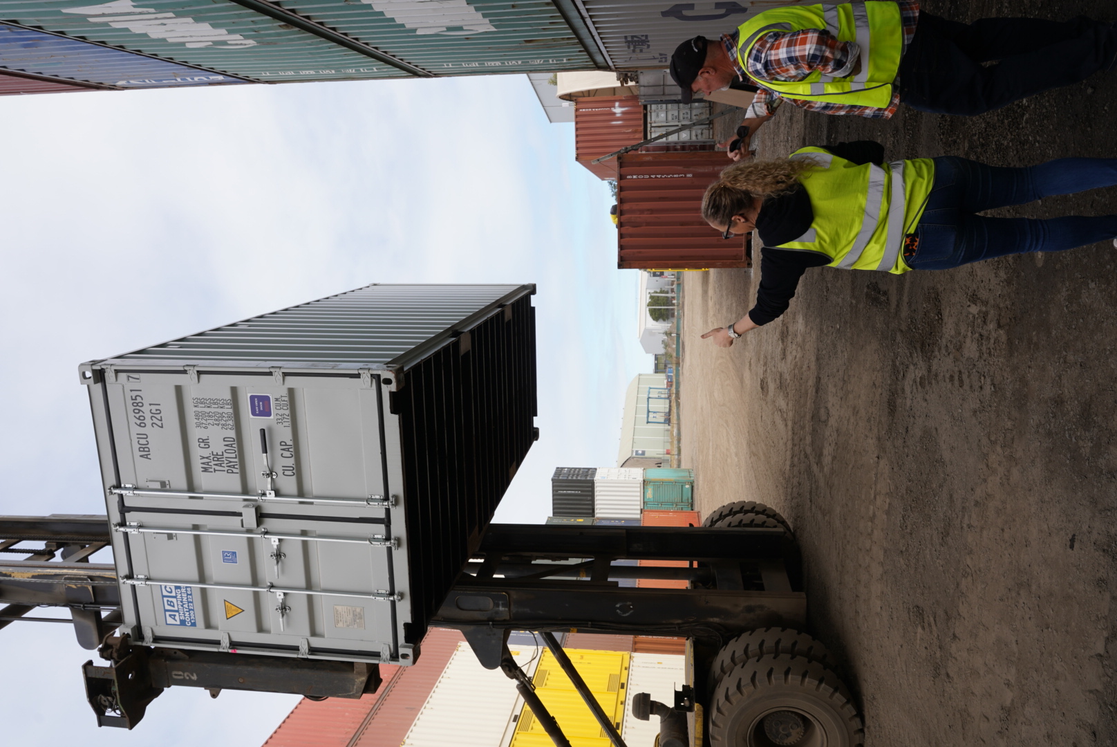 People viewing a shipping container