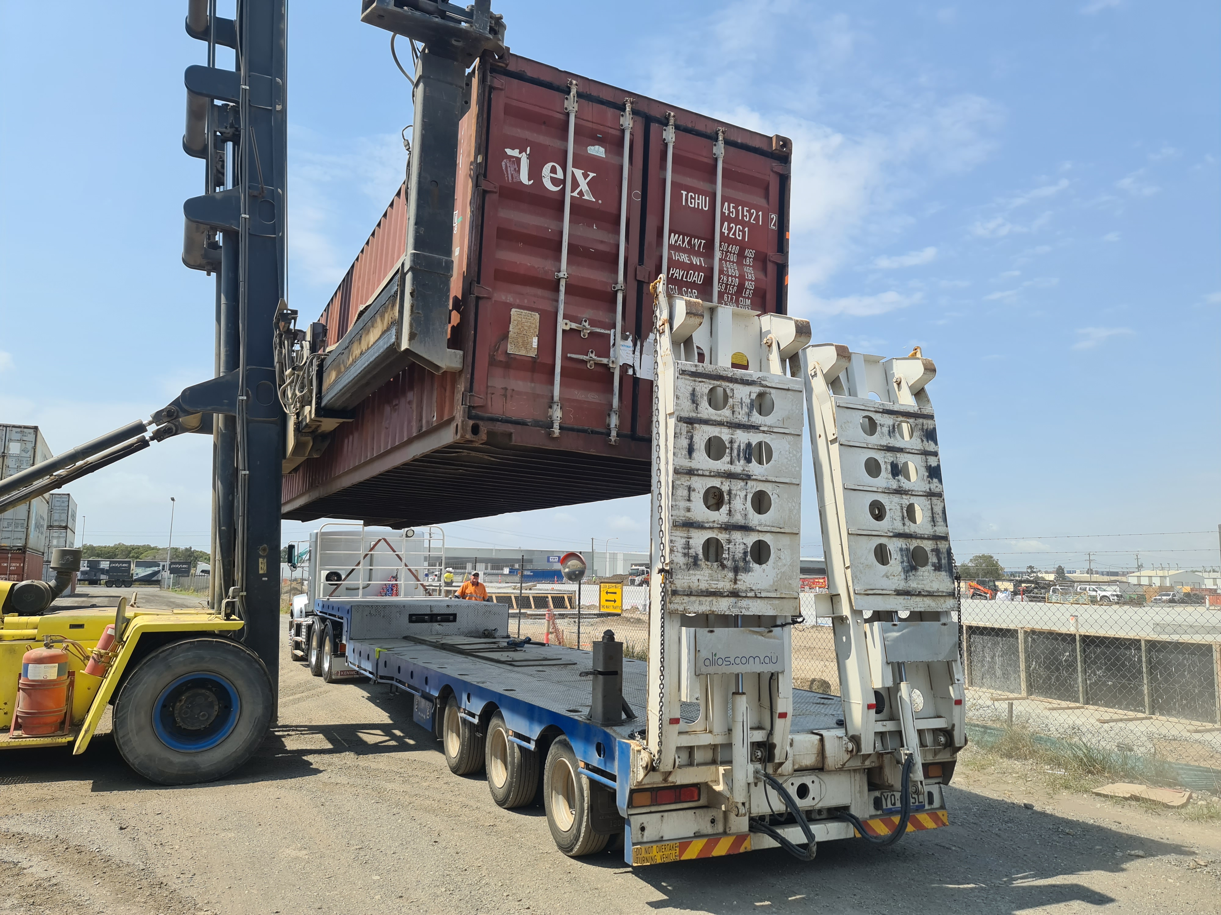 40ft shipping container being loaded onto a truck