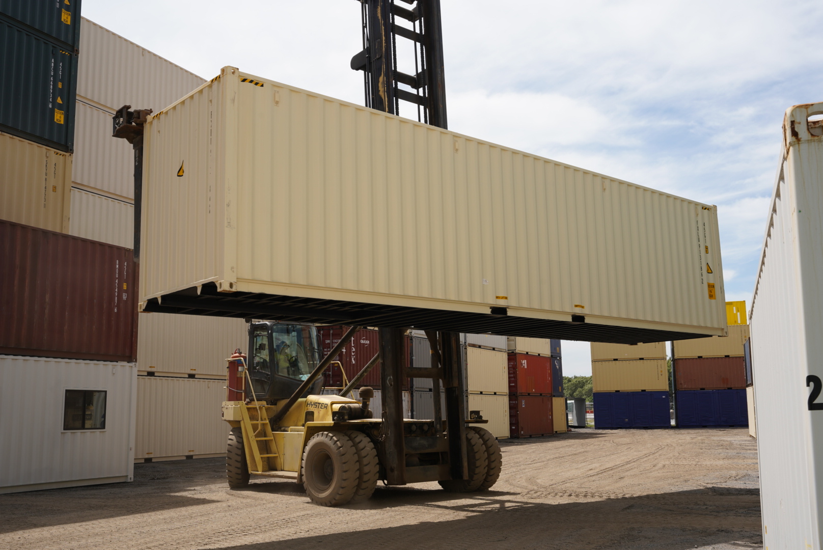 40ft shipping container being lifted by a forklift