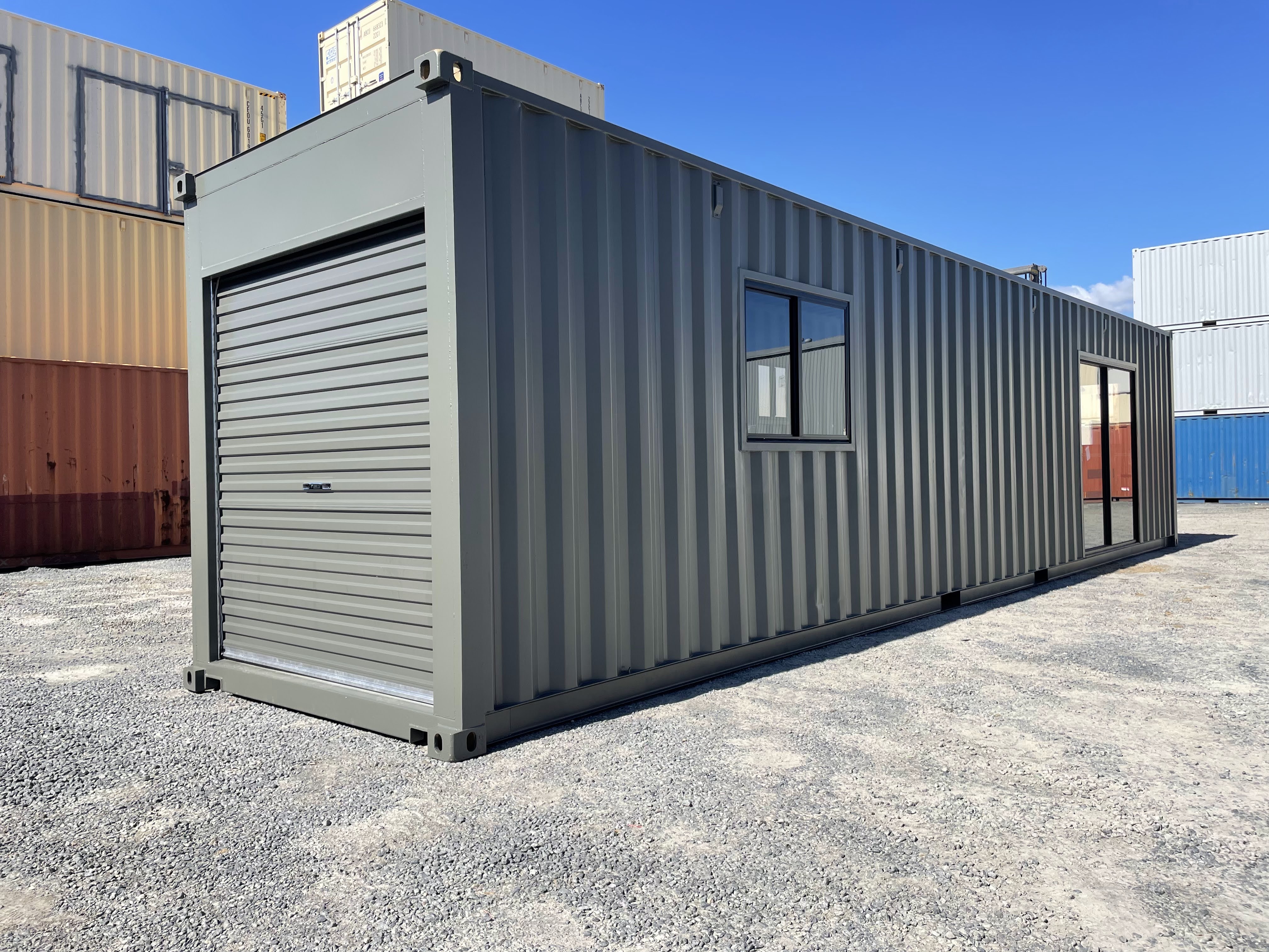 Modified 40ft shipping container with glass sliding door, garage door and a window